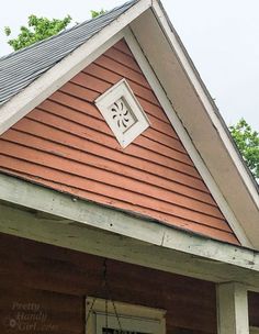 a house with a clock on the front of it's face and window sill