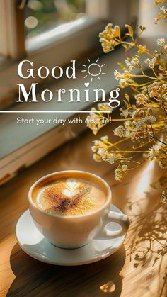 a cup of coffee sitting on top of a saucer next to a vase with flowers