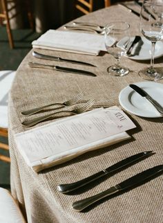 the table is set with silverware and menus