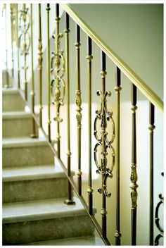 a stair case with wrought iron railing and handrail