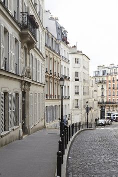 a cobblestone street lined with tall buildings