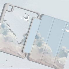 two ipad cases sitting next to each other on top of a white surface with stars and clouds