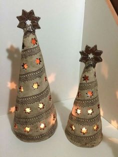 two decorative christmas trees with lights on them