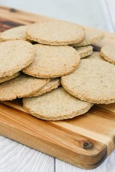 a pile of crackers sitting on top of a wooden cutting board