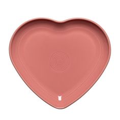 a pink heart shaped dish on a white background