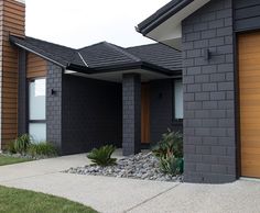 two garage doors are open on the side of a house that is black and brown