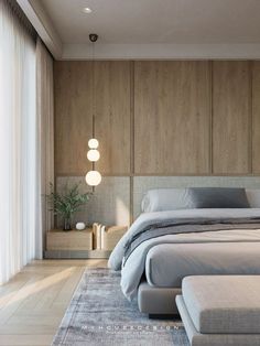 a large bed sitting in the middle of a bedroom next to a tall wooden wall