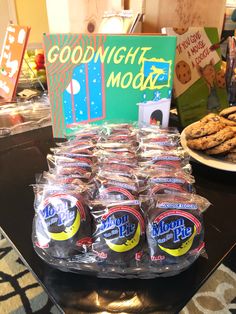 cookies and cookies in plastic bags are sitting on a table next to a good night mood sign