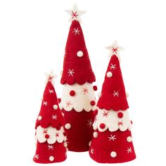 three red and white christmas trees with snowflakes on them, one is made out of felt