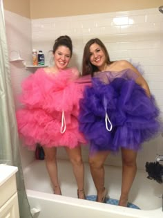 two women standing in a bathtub wearing dresses that look like tulle skirtes