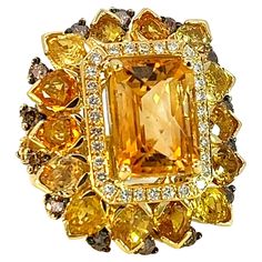 This sunshine stunning ring from S.Georgios designer was handmade in our workshop in Greece from solid 18 Karat Yellow Gold. The ring features 9.7 Carats of Faceted Citrine center surrounded by 10.1 Carats of pear-cut sapphires, a row of Brilliant Cut White Diamonds with a total weight of 0.45 Carats, and 1.38 Carats of Brown Diamonds with Black Rhodium prongs on the outer edge. The band is beautifully shaped to comfort and decorated with Yellow Sapphire hearts and brown diamonds on the sides. T Brown Diamonds, Sapphire And Diamond Ring, Sapphire Diamond Ring, Brown Diamond, Domed Ring, Black Rhodium, Yellow Sapphire, Beast Mode, Beautiful One