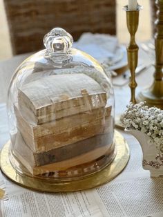 a cake under a glass dome on top of a table