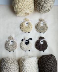 several balls of yarn with sheep faces on them and numbers in the middle one for each