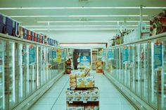 an aisle in a grocery store filled with lots of boxes and containers full of food