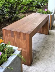 a wooden bench sitting next to two planters