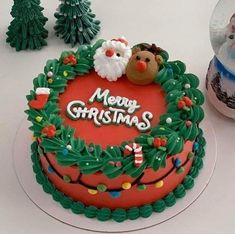 a decorated christmas cake sitting on top of a table