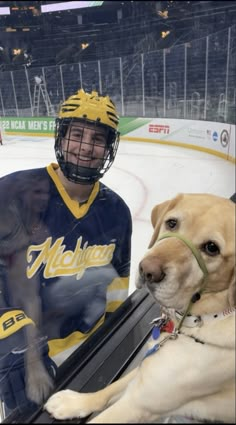 a man and his dog are sitting on the ice