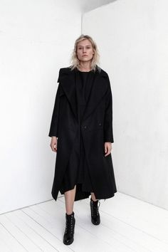 "Premium quality Black woolen coat has an oversize silhouette through the body , crafted in a heavy and thick high quality Italian wool fabric. Calf-length coat is fastened with two knobs. The coat has a unique cut , features big collar, long sleeves and is very stylish. This coat has a horizontal line through the front and back, there are large pockets in front. On one side on the shoulder is a decorative detail. The coat is with viscose lined. This coat is very stylish and unique created by a Black Long Pea Coat With Pockets, Modern Black Wool Coat With Pockets, Modern Oversized Winter Pea Coat, Modern Oversized Pea Coat For Winter, Black Oversized Long Sleeve Pea Coat, Spring Black Wool Pea Coat, Modern Long Outerwear For Fall, Modern Long Black Pea Coat, Modern Black Long Pea Coat