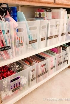 plastic storage bins are stacked on top of each other in this organized craft room