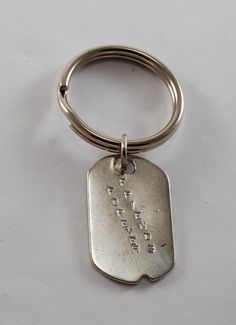 a metal keychain with a small tag on it's side that says, i love you