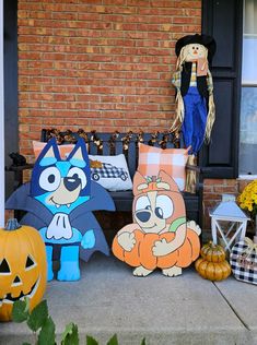 halloween decorations on the front porch with pumpkins and jack - o'- lanterns