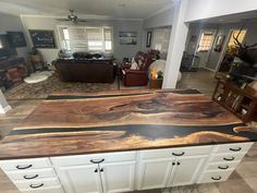 a kitchen island made out of wood and white cabinets