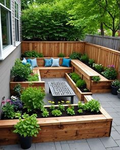 a wooden bench sitting next to a garden filled with lots of flowers and greenery