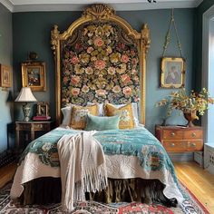 a bedroom with blue walls and gold accents