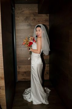 a woman in a wedding dress holding flowers