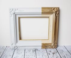 an old white and gold frame sitting on top of a wooden floor