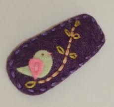 a small purple object with a bird on it's back and gold trimmings