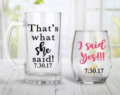 two glass mugs sitting on top of a table next to each other, one with the words that's what she said