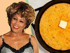 a woman standing next to a skillet with food on it and a piece of cheese