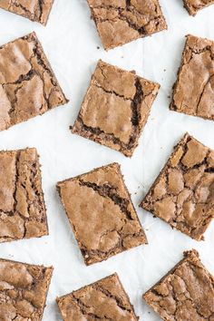 chocolate brownies cut into squares on top of white paper