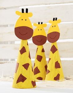 three paper mache giraffes are standing next to each other