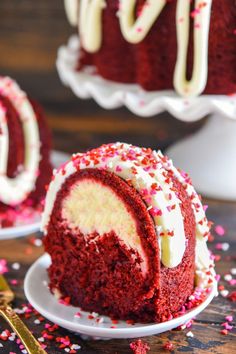 a red velvet cake with white frosting and sprinkles on a plate