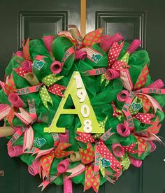 a wreath with the letter a on it and ribbons hanging from it's front door