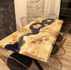 the table is made out of wood and has blue paint on it, along with metal chairs