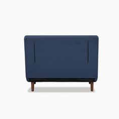 an upholstered blue couch with wooden legs