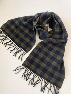 "This is a vintage 90s soft and fluffy wool retro scarf in olive green and dark navy blue. This unisex warm wool scarf is suitable for both men and women. This plaid scarf has a simple print in autumn colors, it will keep you warm and cozy during the cold days. Beautiful vintage gift for the fall and winter season.  Era: 90s Condition: beautifully preserved no visible signs of wear besides that the fabric was probably smoother years ago, but it's still in great shape.  Measurements: Length: 57\" /145 cm + 2.8\" / 7 cm fringe on each side Width: 11\" /28 cm Colors: olive green, dark navy blue Material: not marked, feels like pure wool Shipping: I will ship your item from Varna, Bulgaria. Items shipped within the European Union take around 6-12 working days. Overseas delivery usually takes a Men’s Scarves, Elegant Tank Tops, Retro Scarf, Tartan Plaid Scarf, Velvet Turban, Scarf Trends, Rainbow Scarf, Winter Scarves, Velvet Hat