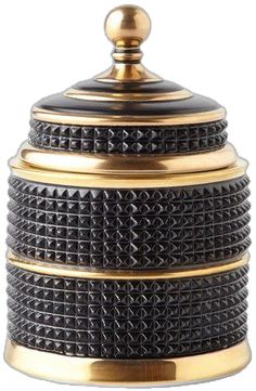 a black and gold container with spikes on the top is sitting in front of a white background