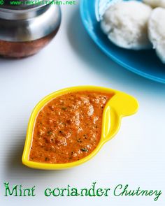 there is a small yellow spoon with sauce in it next to some food on the table