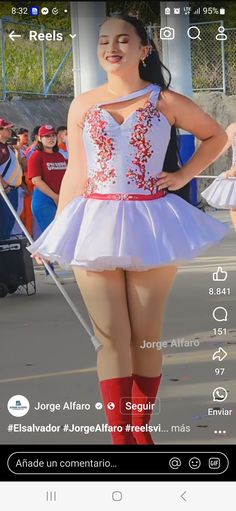 a woman in a white dress and red boots