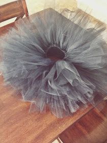 a chair with a tulle sitting on top of it next to a wooden table