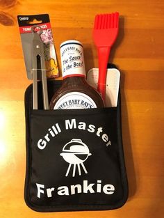 the grill master's frankie pouch is filled with bbq sauce and barbecue tools