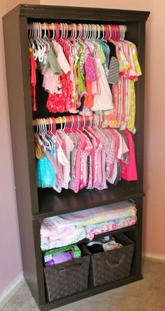 an organized closet with baby clothes and diapers on it's shelves in a child's room