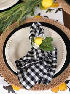 a black and white checkered napkin with lemons on it sits on a plate