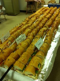 many sandwiches are lined up on the table