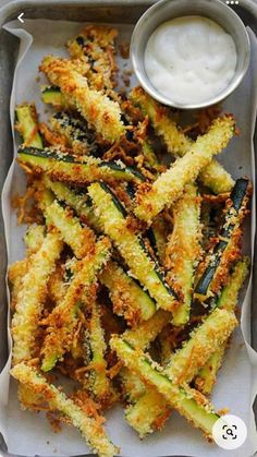 fried zucchini sticks with ranch dressing in a tray