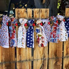 an old fence is adorned with patriotic ties